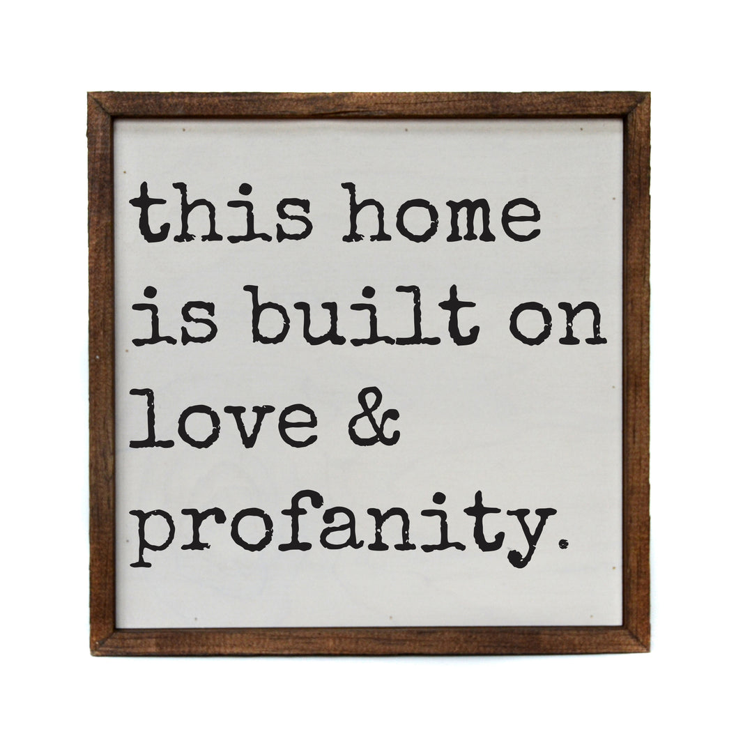 10x10 This home is built on love & profanity - CW119 - 2 Per Pack ($11.00 Per Sign)